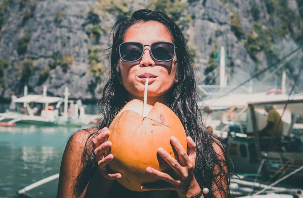 woman drinking coconut juice