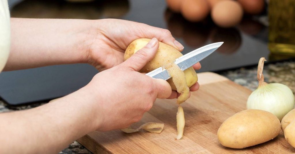 woman peeling potatoes