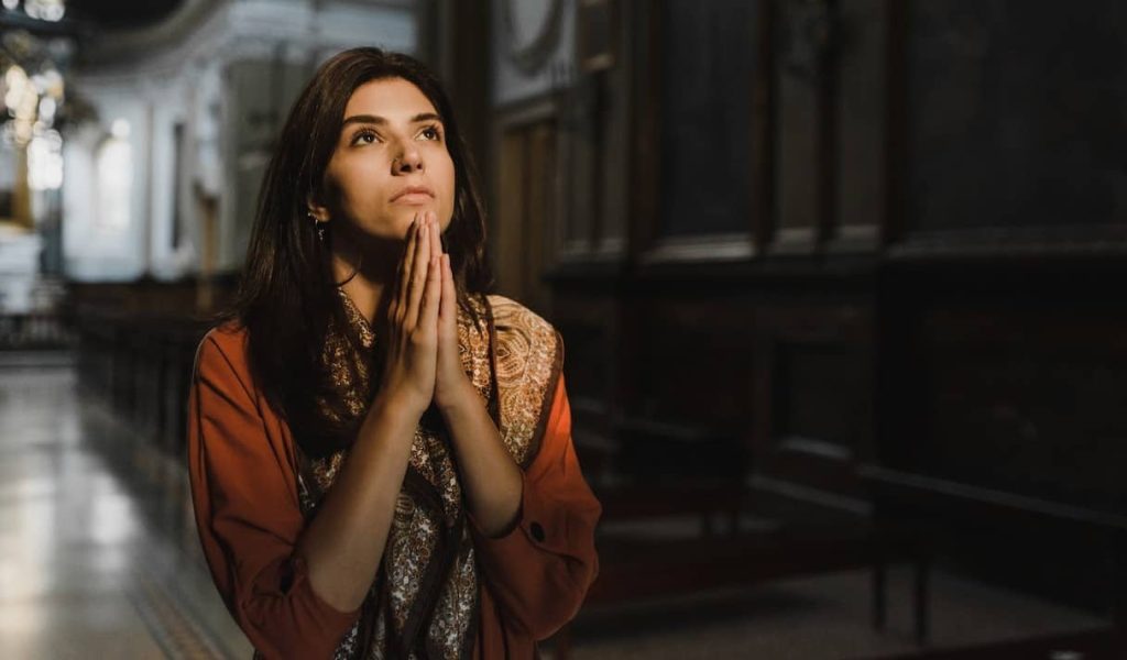 woman praying on a church