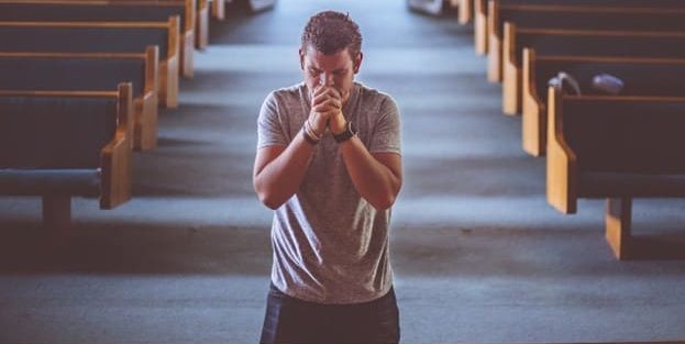 man praying at church