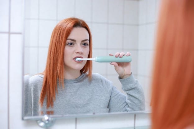 woman brushing her teeth