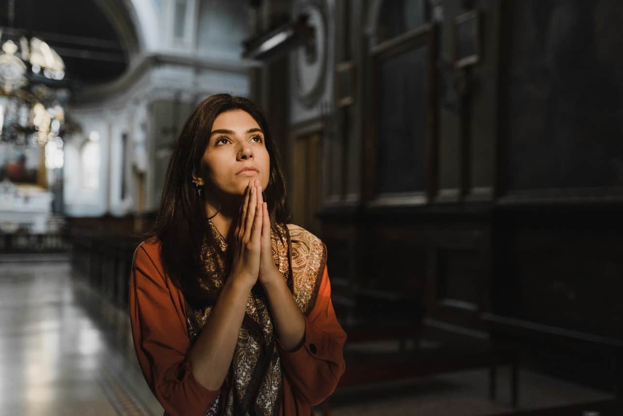 woman praying inside church