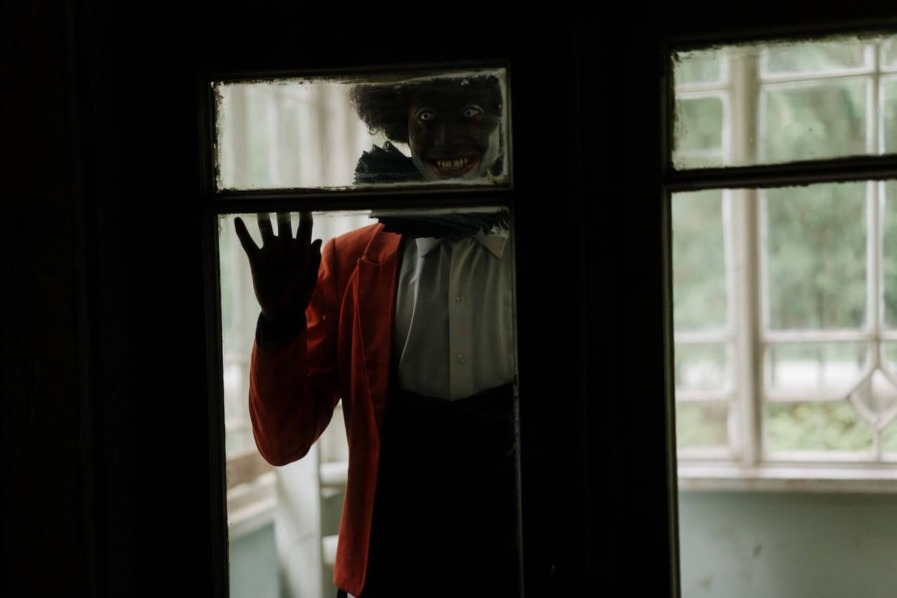 creepy clown behind a glass door