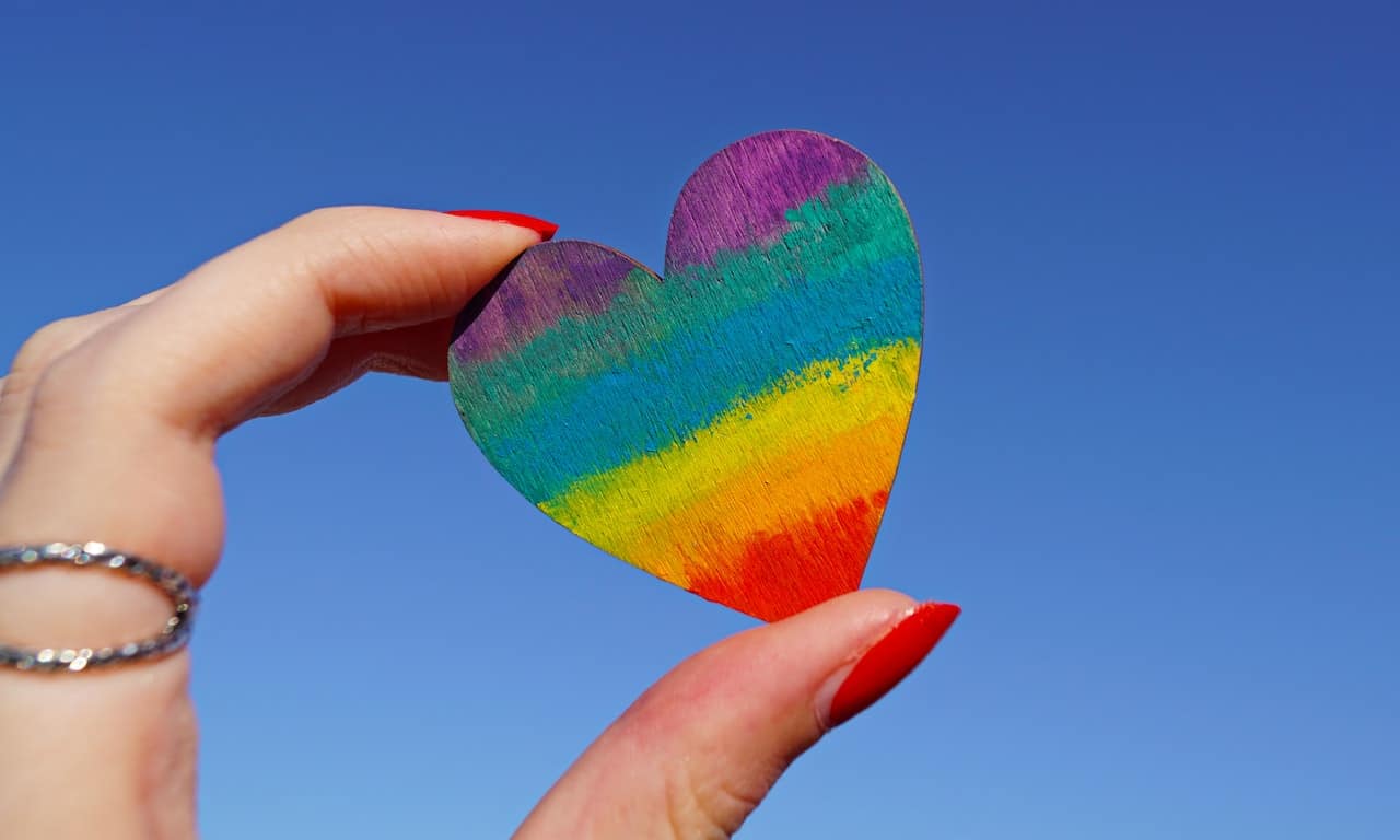 person holding multicolored heart