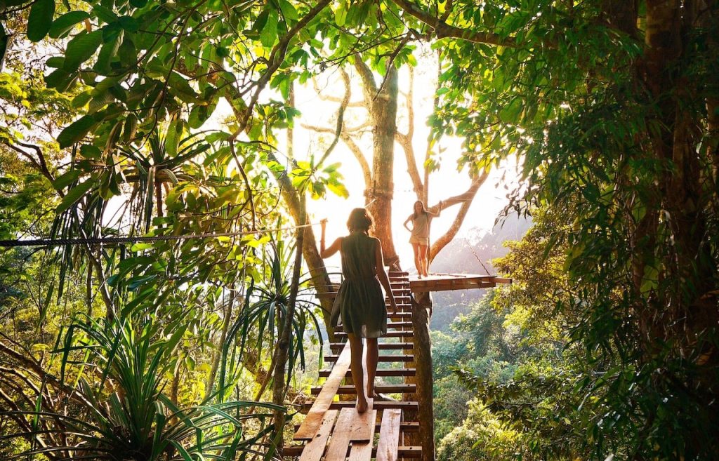 woman crossing a bridge